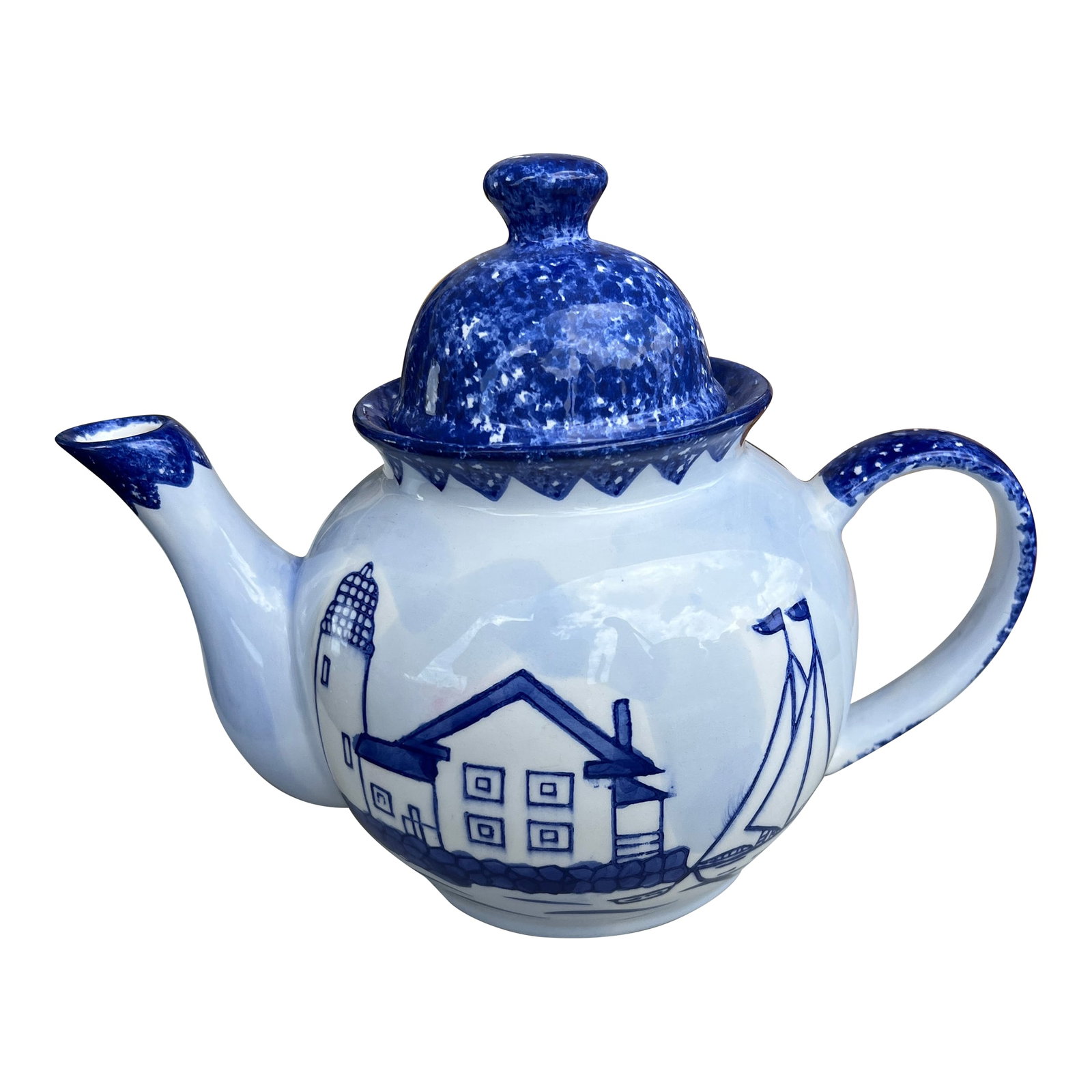 Vintage Ceramic Tea Pot Nantucket: Vintage blue and white ceramic teapot with a nautical theme. It features a distinctive blue and white color scheme with a lighthouse, a house, and a sailboat depicted on its sides, reflecting a