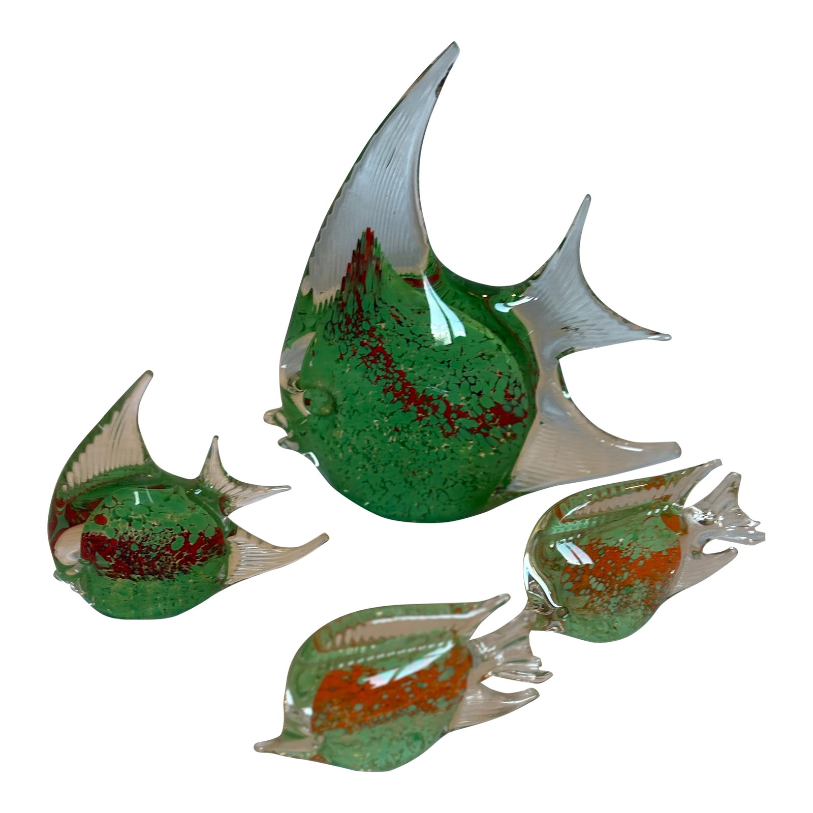 Set of Four Mid 20th Century Murano Fish: Four Murano Glass fish in various sizes. While all the fish are green, one fish is much larger than the other 3. Each fish is classic Murano with variegated colors and clear glass fins. The larger fis