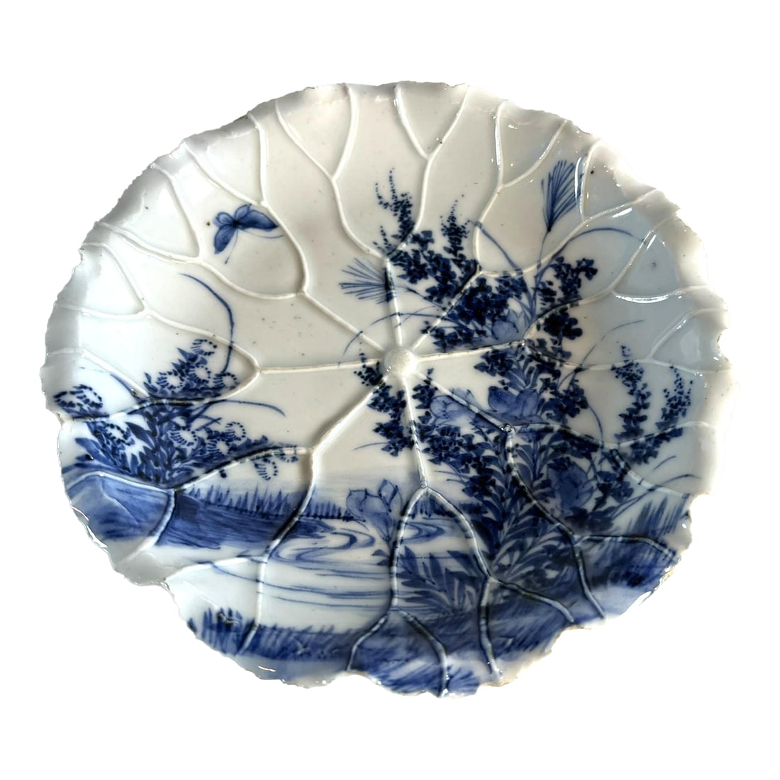 Meiji Period Arita Blue and White Porcelain Plate in the Shape of a Lotus Leaf: There is a quality of Japanese porcelain that stands on its own. I like the clarity of the white porcelain and the sound it makes when pings. Creativity in design is another feather, and always a