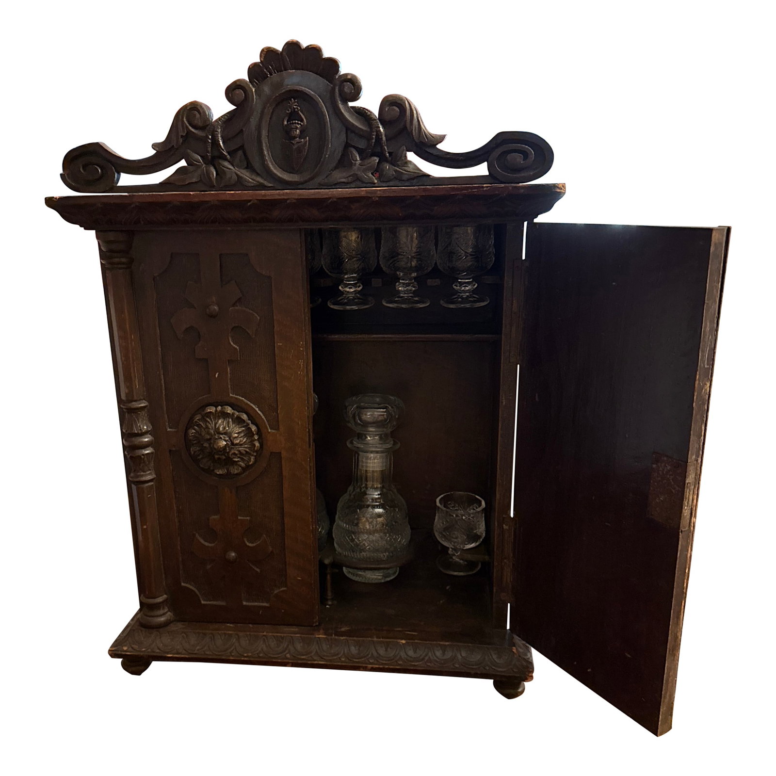 Late 19th Century Black Forest Cave a Liqueur Armoire: A wonderful late 19th century hand carved black forest cave a liqueur tantalus decanter and cordial cup set in the from of a 2 door miniature armoire with carved pilasters, rosettes, and crest.