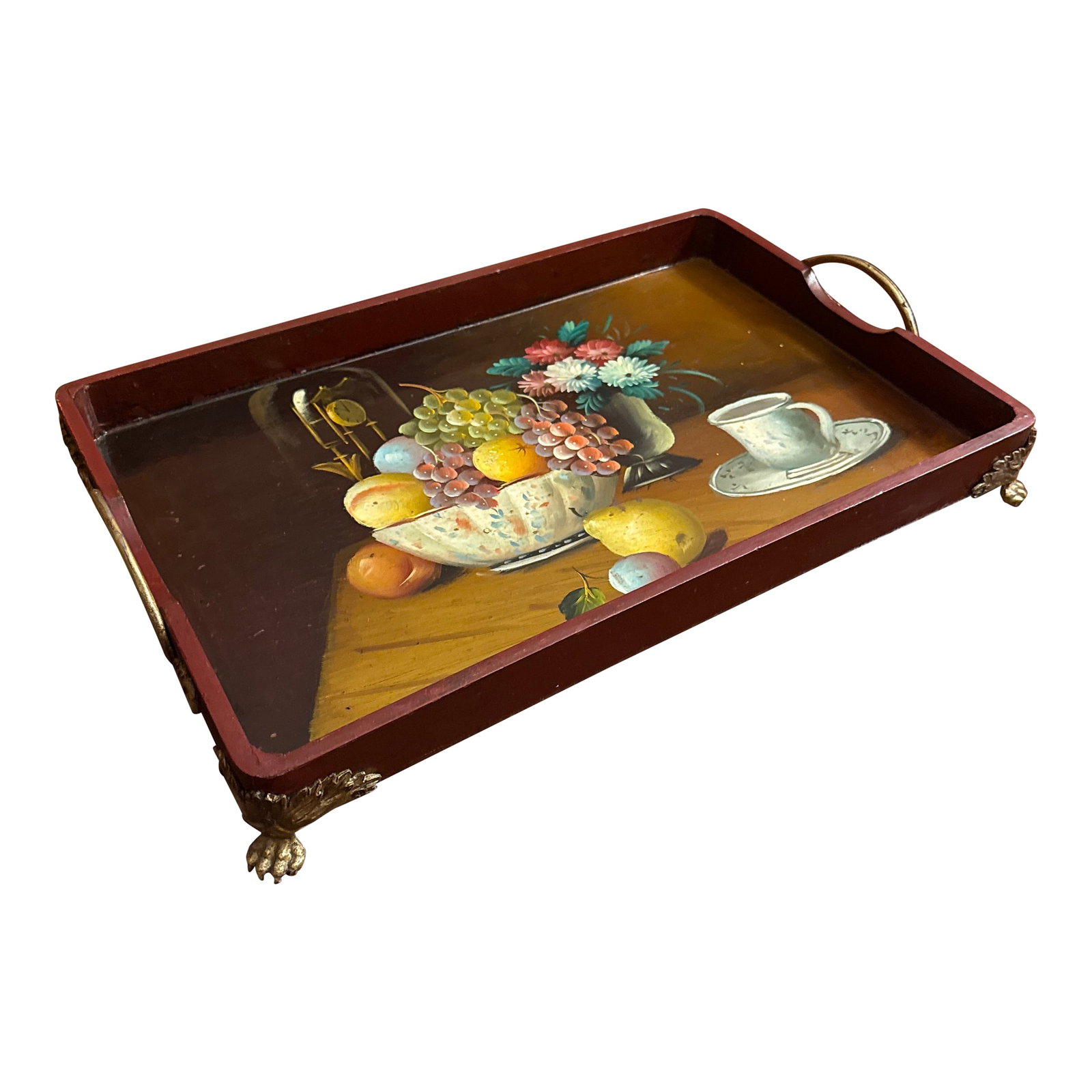 Hand Painted Tray: Lovely hand painted wood tray with brass paw feet and brass handles with acanthus foliage. Deep red ground, blue and white porcelain, fruits, tea cup and saucer, flowers, brass anniversary clock in