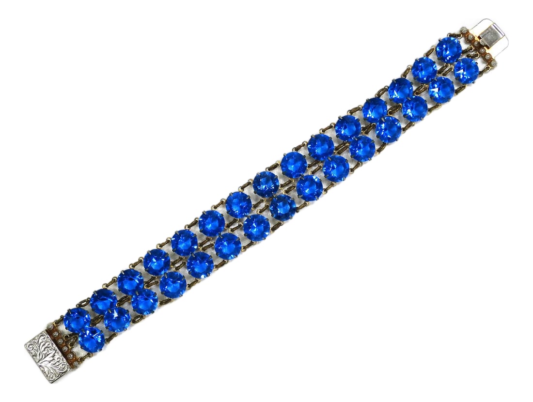 Vintage Austrian Sapphire Crystal Bracelet 1950s: Vintage silver-plated Austrian sapphire crystal link bracelet 1950s. Linked open-back cup settings with round faceted crystals in a bright sapphire hue, finished with millegrain bars and an etched