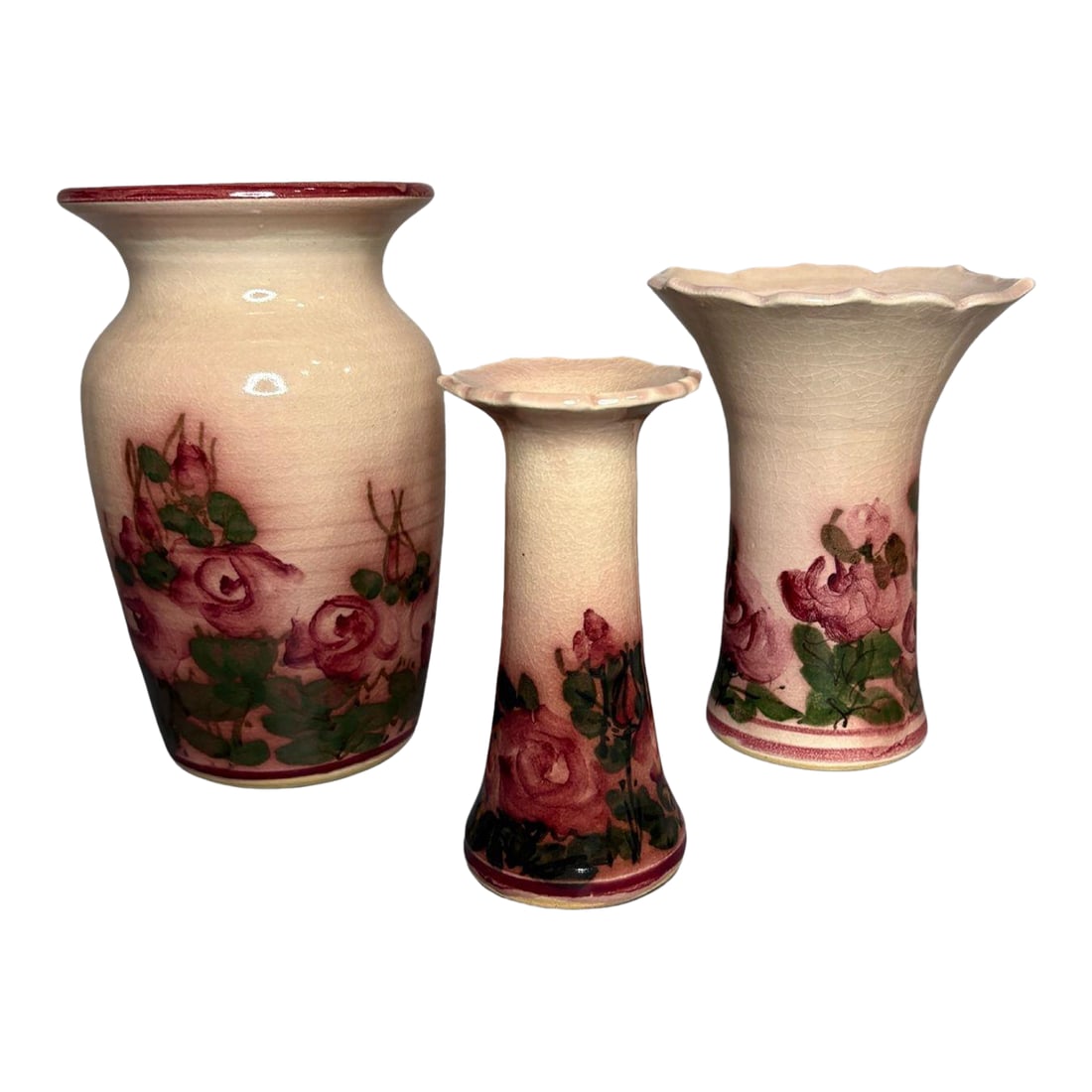 Vintage Hand-Painted Rose Motif Studio Pottery Vases - Set of 3, Signed Artist Mark Mj: A charming vintage set of three hand-thrown studio pottery vases, each individually shaped and hand-painted with romantic rose motifs in soft blush, cranberry, and leafy green tones. The forms vary