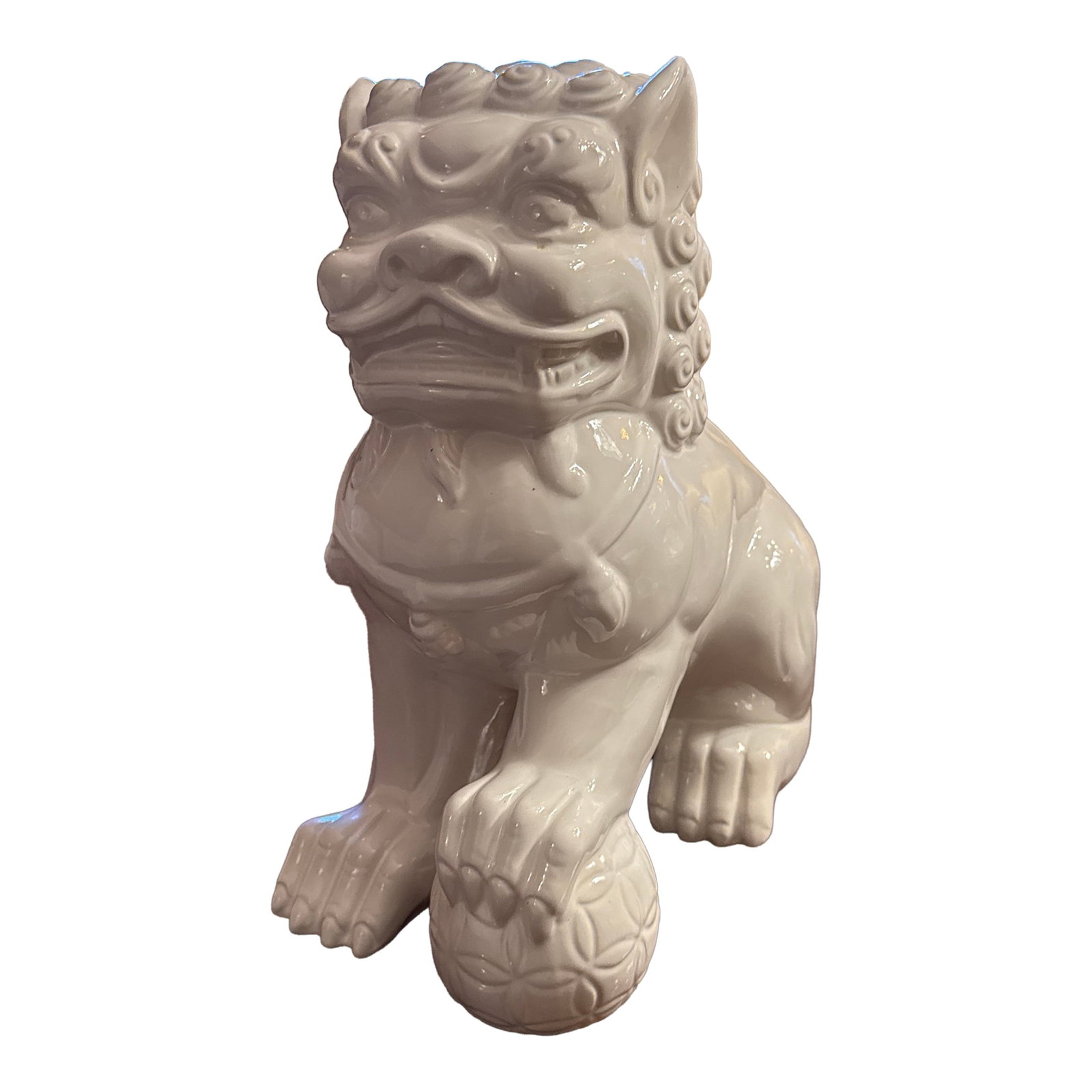 Blanc De Chine Foo Dog: Mid-century, modern white glazed, ceramic foo dog statue with right foot on a decorative sphere. Condition: Alterations: Original Condition Unaltered Imperfections: Some Imperfections Condition Notes: