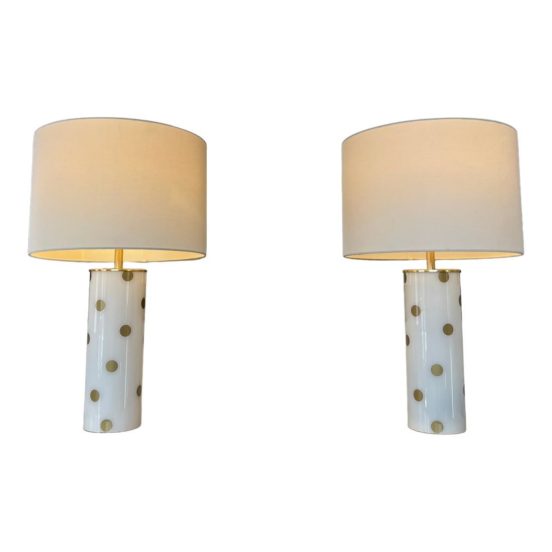 Kate Spade Cream & Gold Pavilion Polka Dot Cylinder Table Lamp W/ Cream Linen Shade; Set of 2: Classic Kate Spade Signature design, this Pavilion Dot table lamp features a frosted cream glossy glass cylinder base with metallic gold polka dots and brass accents. Kate Spade New York partnered wit