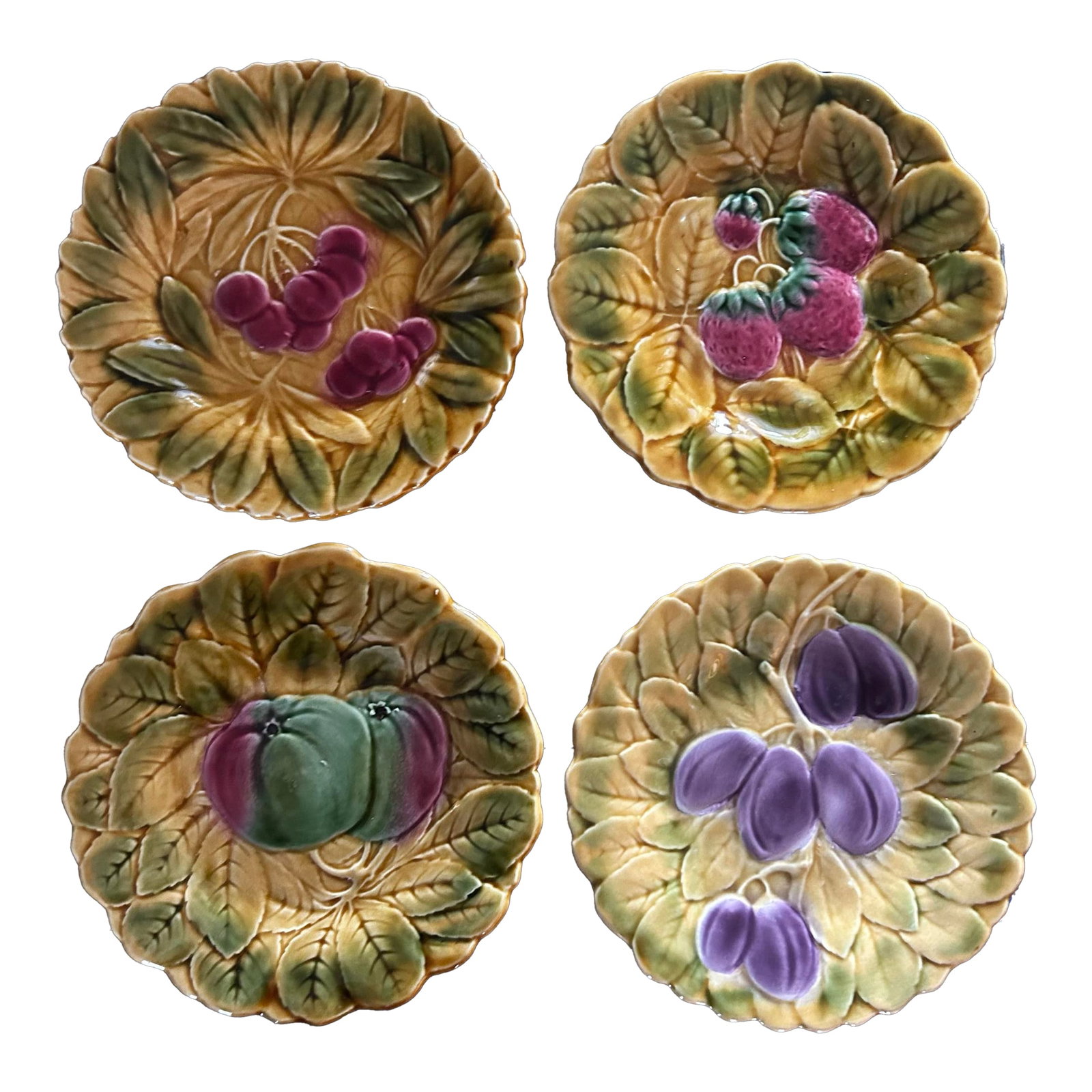 Set of Four French Majolica Figural Fruit Plates by De Sarreguemines: Set of four vintage French majolica fruit plates by de Sarreguemines. Measuring 7.5" across, each plate depicts a different fruit. Condition: Alterations: Original Condition Unaltered Imperfections: