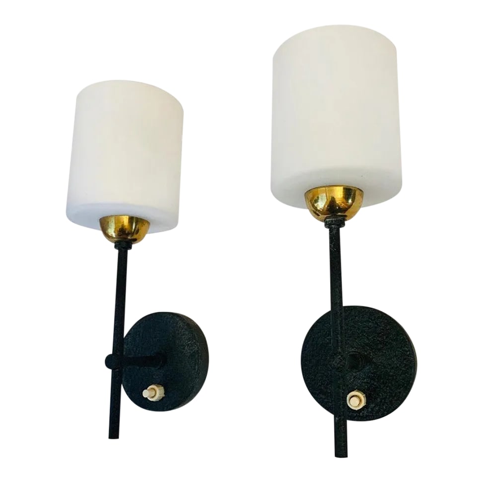 Lunel French 1960s Wall Lights - A Pair: A pair of black enamel and polished brass sconces with white opaline shades. Newly rewired. Condition: Alterations: Original Condition Unaltered Imperfections: Some Imperfections Condition Notes: