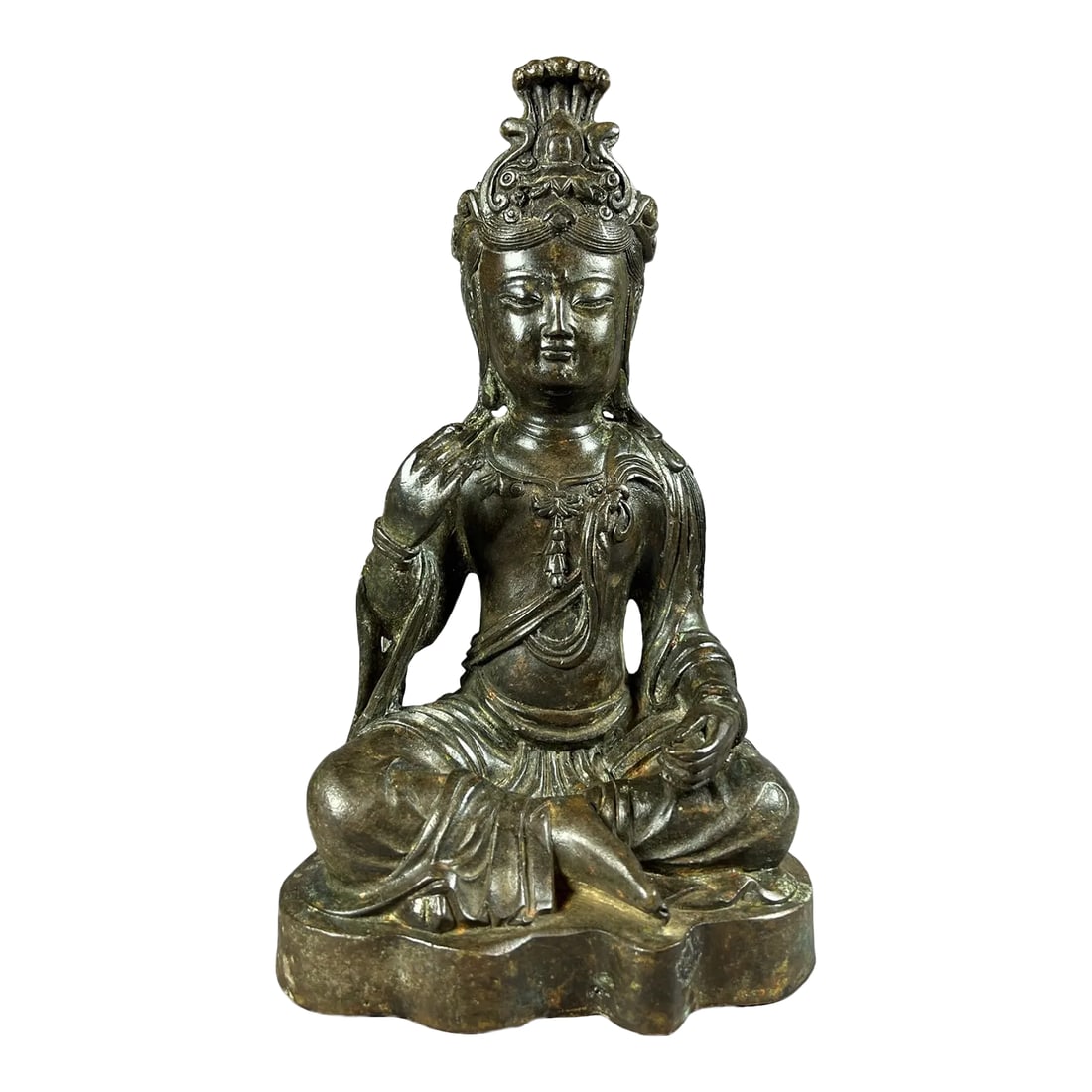 1920s Seated Bronze Bodhisattva: The Bronze Bodhisattva is seated upright in a lotus position or padmasana, a meditation pose on a base. The hands are in a Varana Mudra, the boon granting mudra. Mudras are prescribed hand and finger