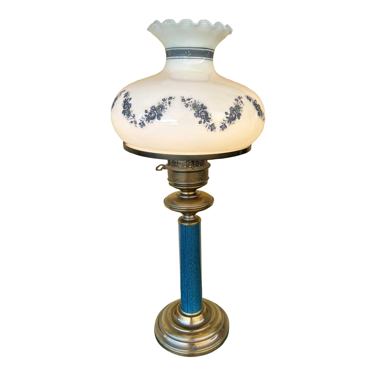 Mid 20th Century Glass Shade Lamp: Vintage toleware blue lamp. White milk glass shade with decorative wave of small blue flowers and a thick blue band around the narrow neck of the glass globe. The top of the glass globe is ruffled. Me