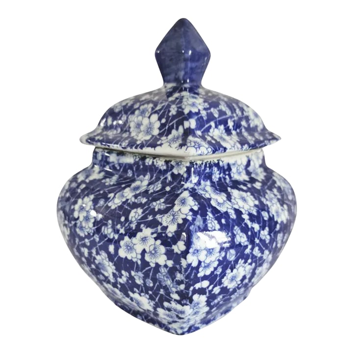 Blue and White Chinoiserie Earthenware Jar With Lid: A charming, country Delft style earthenware jar, with stylized blue and white depictions of flowers throughout, with cover surmounted by a diamond shaped finial. Dimensions: 6.5" x 6.5" x 9" H