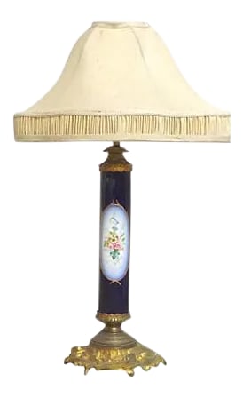 Antique Porcelain Sevres Lamp: Antique; 19th century, French, porcelain, Sevres, lamp with hand-painted floral on one side and 17th-century musician on the other. Brass acanthus leaf base and cap. Gilt accents. Silk Edwardian bell-