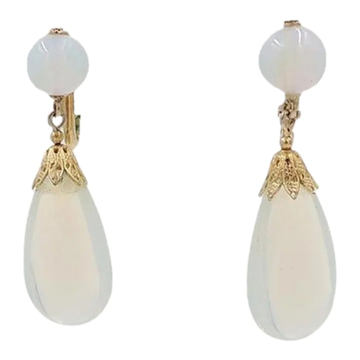 Vintage 1960s Signed Napier Faux-Moonstone Rhinestone Drop Clip Earrings - 2 Pieces: This is part of Chairish's Costume Jewelry assortment. 1960s goldtone faux-moonstone rhinestone drop clip back earrings. Marked "Napier." Condition: Top of one earring has been glued in place, otherwi