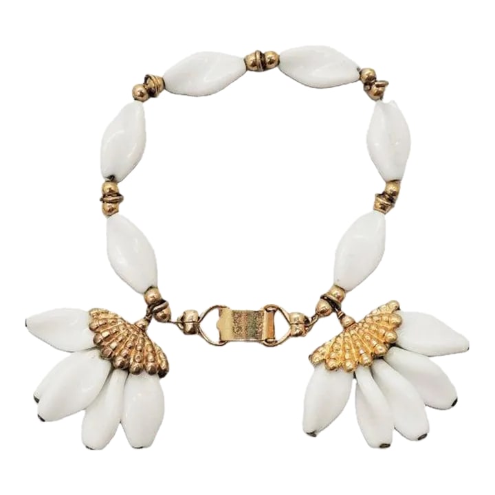 Vintage 1950s Signed Napier Goldtone & White "Fans" Charm Bracelet: This is part of Chairish's Costume Jewelry assortment. 1950s goldtone and white beaded with two "fans" charm bracelet with fold over clasp. Marked "Napier." Measures: 7 1/4 inches long by 1 1/2