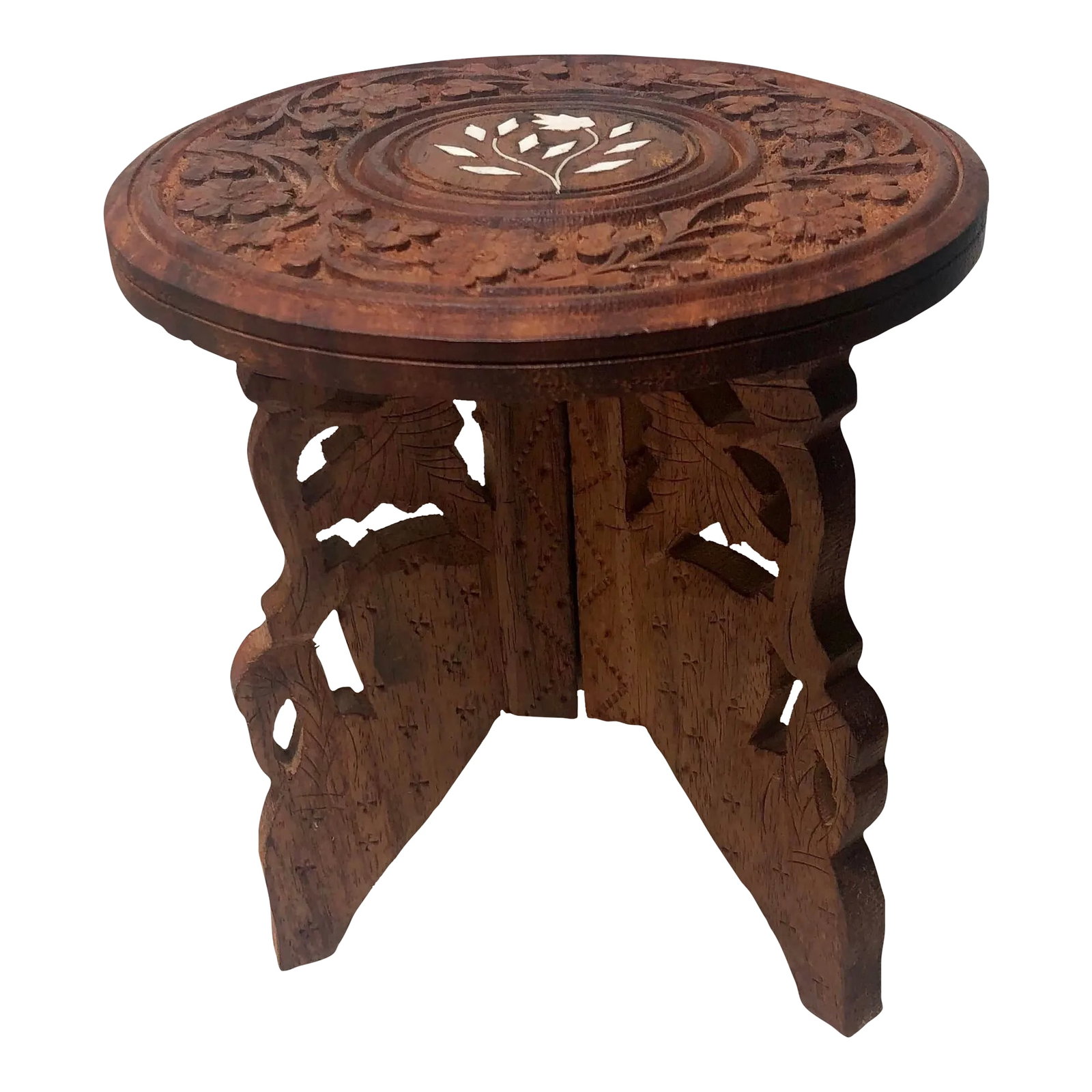 Mid-Century Anglo-Indian Small Hand Carved Floral Folding Table: This is an exquisite small hand carved folding table. The top / trivet is a striking hand-carved intricate floral design with a beautiful floral inlay. Base is a unique flamingo design. A perfect stan