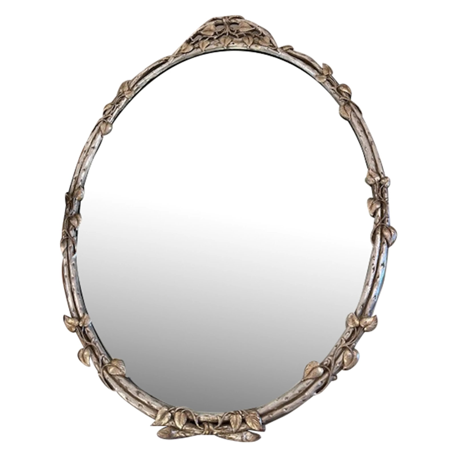 Silver and Gold Leaf Oval Mirror: This is a vintage mirror with a vine and leaf detail throughout. Oval in shape this mirror has just the right amount of patina and would be perfect for an entry or powder room. Very small nick on the