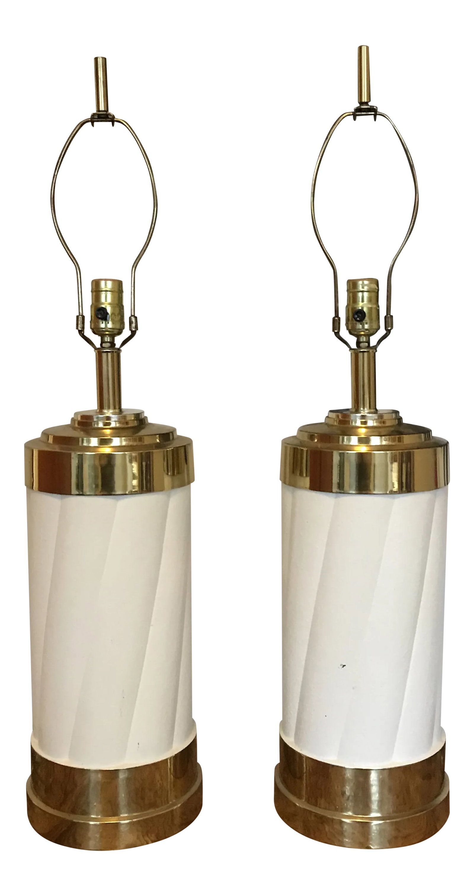 1980s Brass & Enamel Lamps - a Pair: Fabulous pair of 1980's art deco lamps in solid brass with cream spiraled enameled center portion. Harps and finials included. 21.5" to the top of the socket 30" to the top of the finial Condition: Al