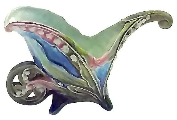 Antique Majolica Wheelbarrow Cachepot: An antique, 19th century, French, Art Nouveau-style, majolica, floral, wheelbarrow, ceramic cachepot. Art Nouveau-style lily of the valley supported by a decorated wheelbarrow. Condition: minor wear. 