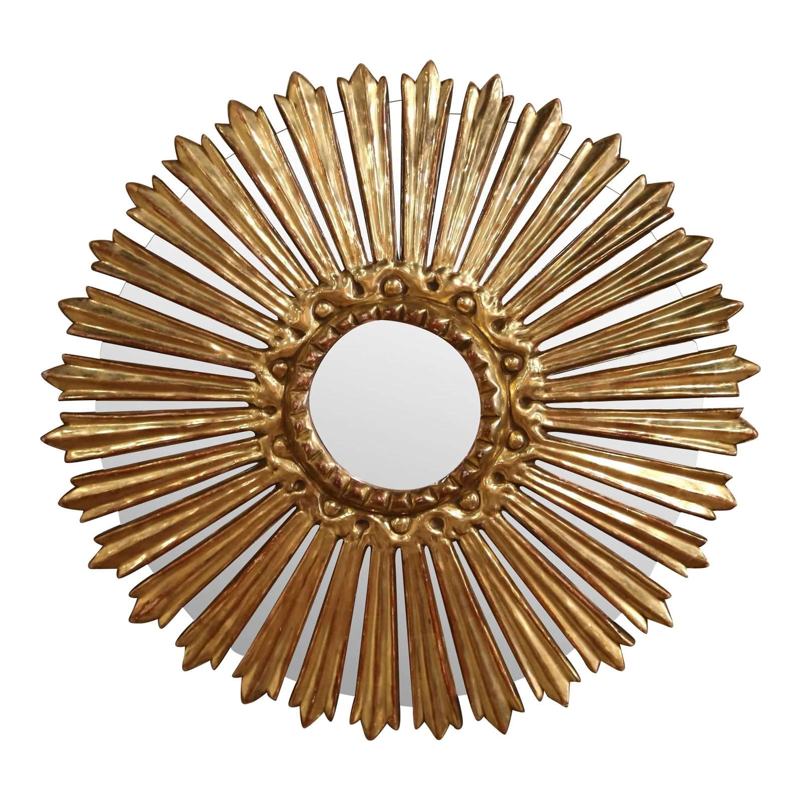 Mid-Century Italian Carved Giltwood Sunburst Wall Mirror With Mirrored Rays: Bring a radiant touch to your home with this eye-catching gilt wood sunburst mirror. Hand-carved in Italy circa 1970, this vintage sun-shaped wall decor features a circular central mirror, framed by m