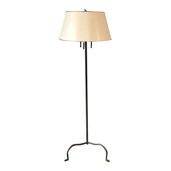 Artemis Antique Brass 3 Bulb Floor Lamp: The metal lamp has a hammered antique brass finish, with triangular column raised on 3 curved legs, triple sockets with chain pulls ending with brass tassels, ivory paper shade with gilt trim,