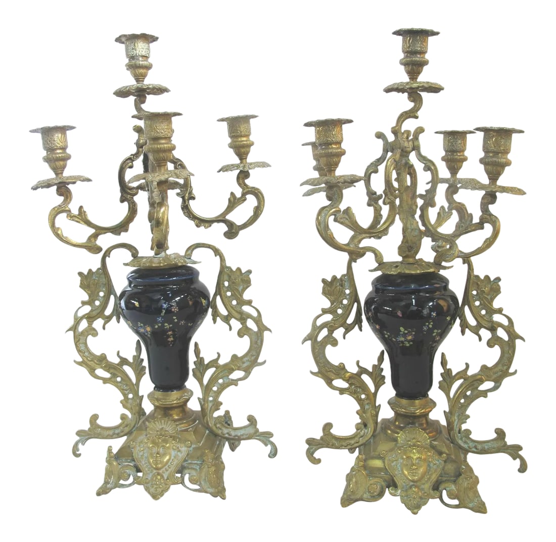 Antique Floral Cloisonne Gold Gilt Brass Figural Medallion Candelabras - a Pair: Beautiful antique candelabra set of 2. Each in gold gilt brass with cobalt blue cloisonne body. Ornate scrolling leaf design with figural medallion at base. Each measures 18" tall x 9". Both are in ex