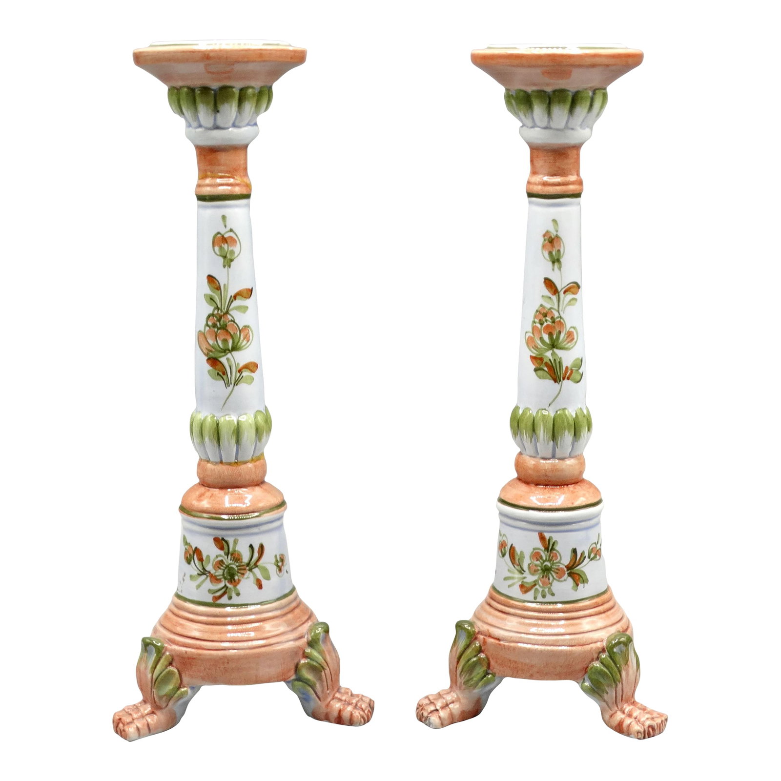 Glazed Italian Candlesticks With Paw Feet, a Pair: Lovely pair of Italian faience candle holders hand with a floral motif raised on a trio of paw feet. They are hand painted and glazed in gorgeous colors of white, blush-pink, and green and have a