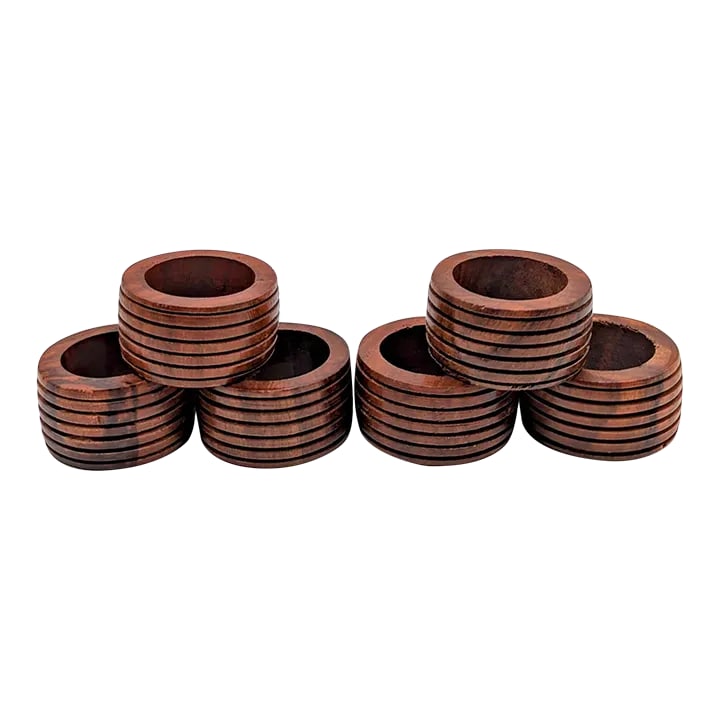 1980s Carved Mango Wood Napkin Holders, Set of 6: This is a set of six hand-carved and varnished Mango wood napkin rings made in India in the 1980s. They each have six carved rings, yet they are simple in design and form and not the least bit