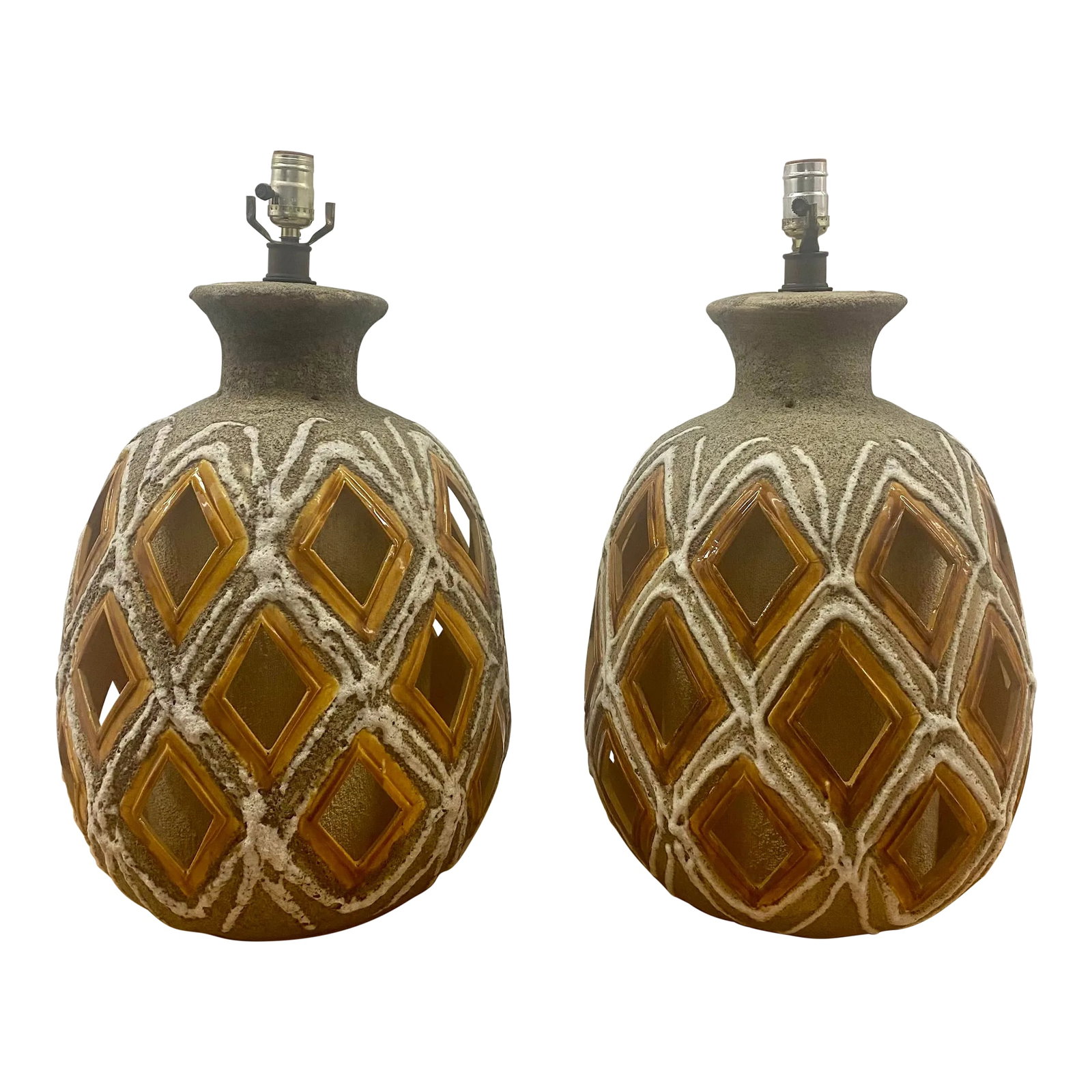 70s Large Brutalist Ceramic Table Lamps a Pair: Pair of Brutalist hand crafted Ceramic table lamps, oval shape with textural design, switch at the bottom for the inside fabric cover and on top. Shades are no included. 24" to the socket. Condition: