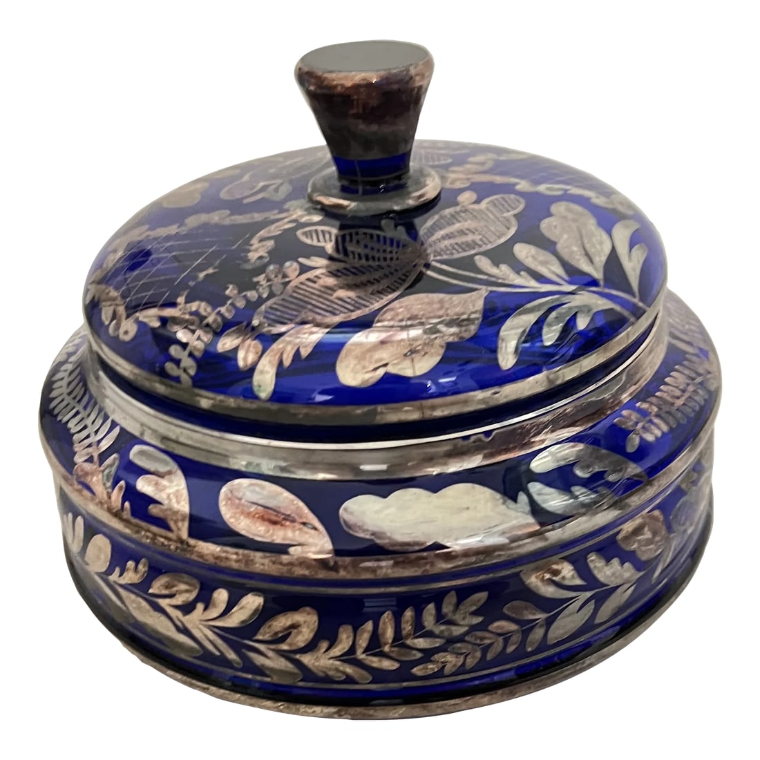 Early 20th Century Blue Glass & Silver Floral Overlay Bowl With Lid: Early 20th century wide cobalt blue glass lidded bowl. Beautiful silver overlay floral design. With the lid it stands 7" tall and has a diameter of 8". Beautiful piece to add to your room decor.