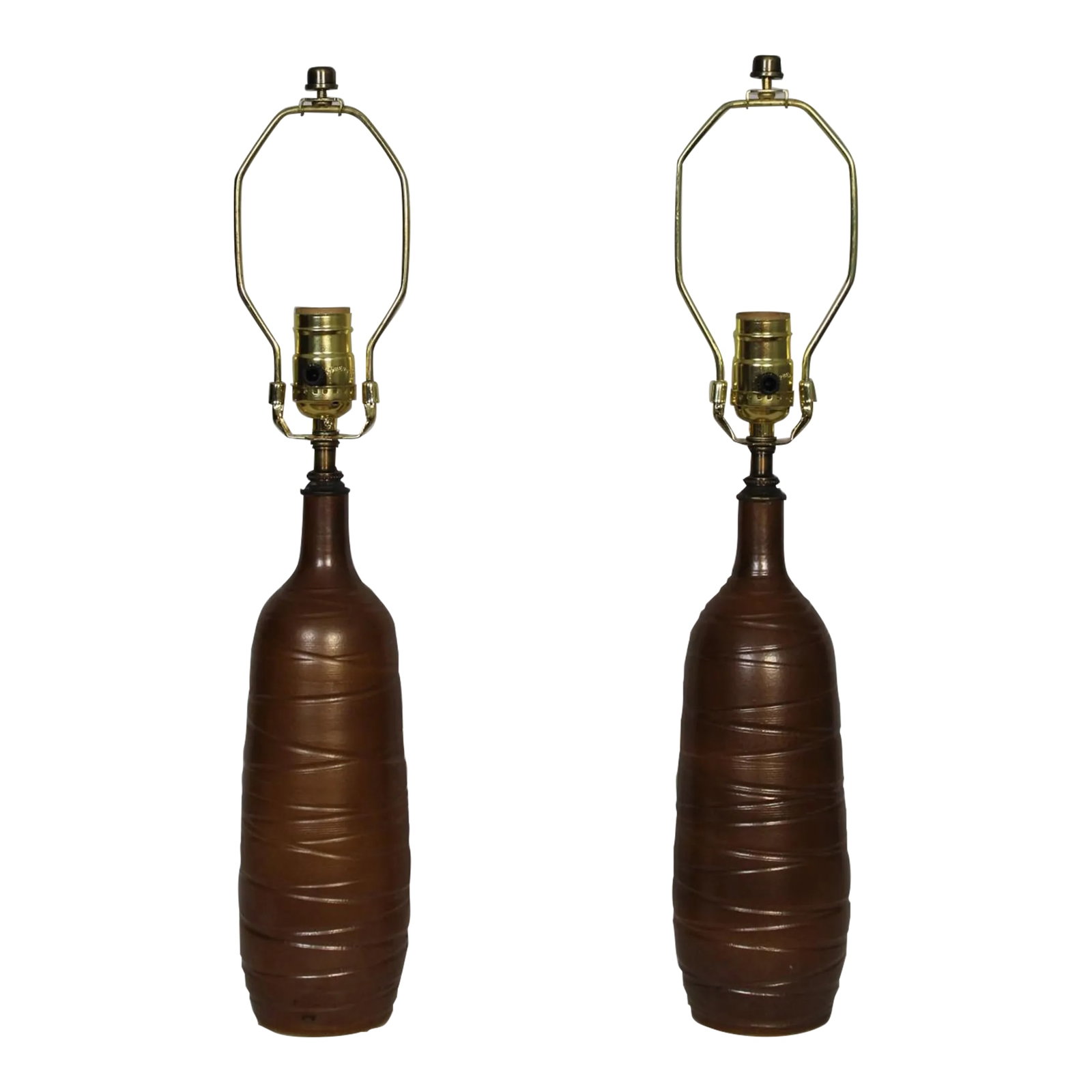 Mid 20th Century Pair of Antonio Zen Influence Lamps: Pair of unusual stoneware lamps. Beautiful Taupe glaze, with circular etching. Giving both depth and texture. Petite in scale. Dimensions are 3.5 diameter. 12 inches tall. Shown with 12 x 12 x 8.5