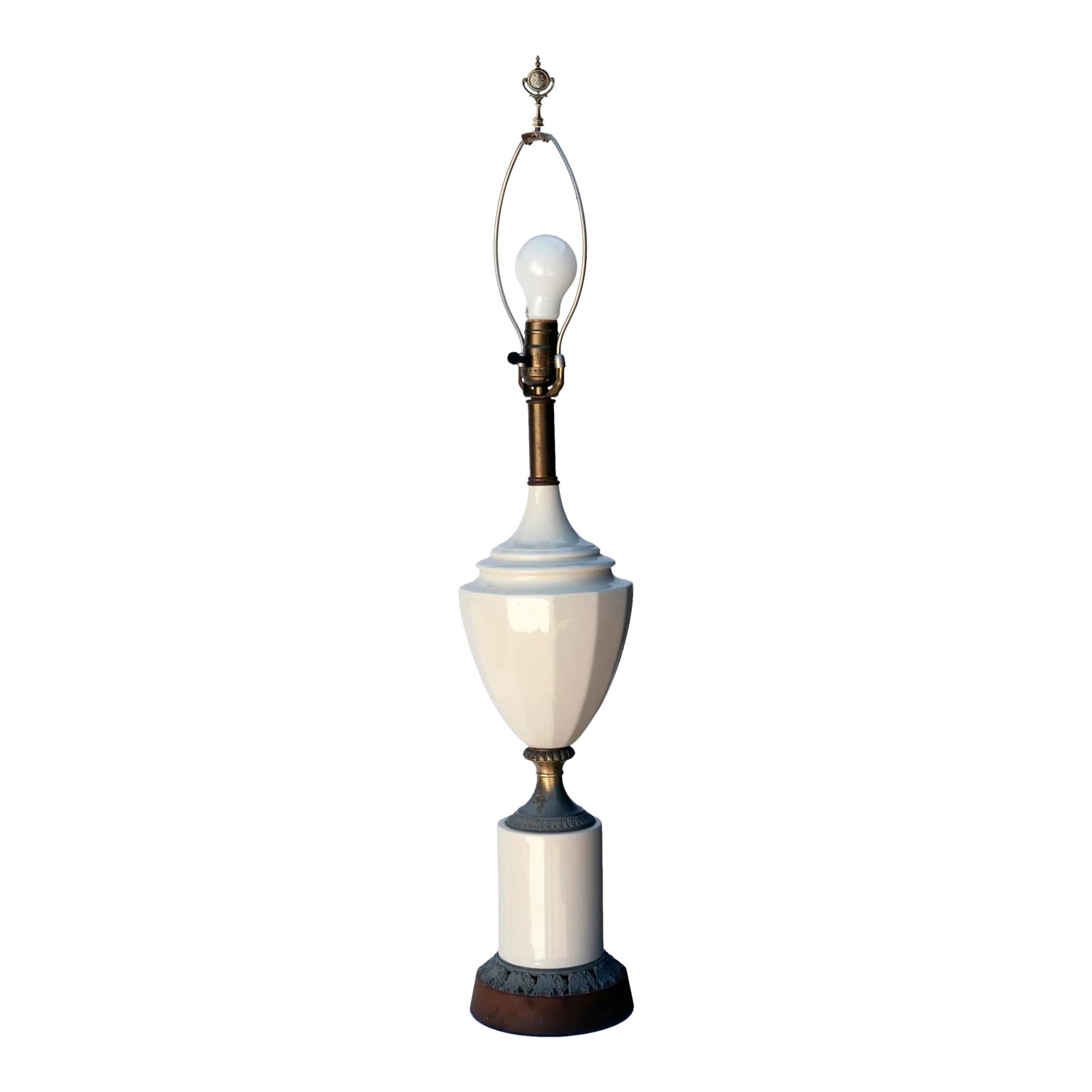 Mid 20th Century Blanc De Chine & Metal Urn Lamp on Pedestal: Blanc de Chine tall, faceted urn which sits on a tall ceramic pedestal trimmed with aged metal leaves and grapes surrounding the base. Graceful form. A tall European finial is included. The lamp sits 