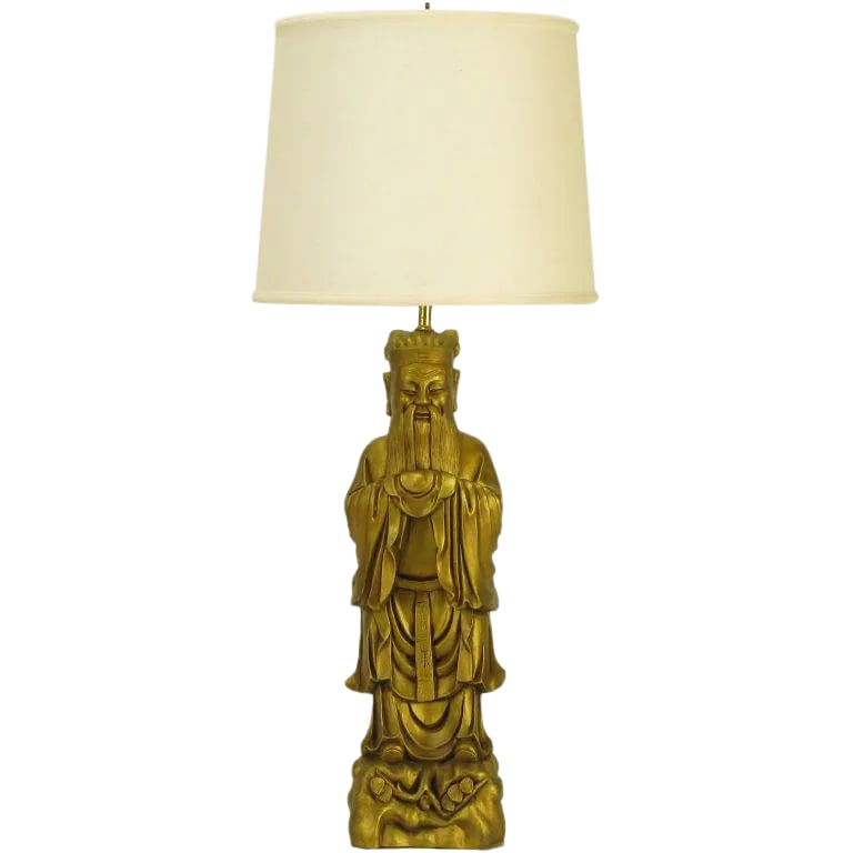 Confucius Gilt Metal Table Lamp: Cast metal and gilt finished table lamp in the image of the famed Chinese philosopher Confucius. An obvious James Mont and Tony Duquette influence. Sold sans shade. Condition: Alterations: Original
