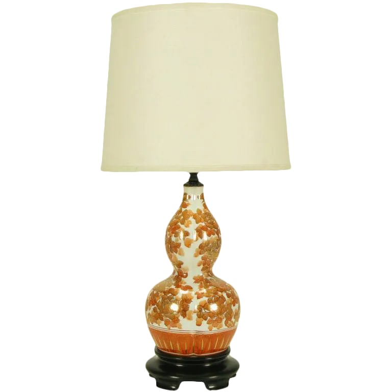 Hand Painted Persimmon Peonies & Parcel Gilt Table Lamp: Double gourd form ceramic hand painted and parcel gilt Asian inspired table lamp with footed black lacquered carved and stepped wood base. Persimmon colored peony flowers and foliage outlined in gilt