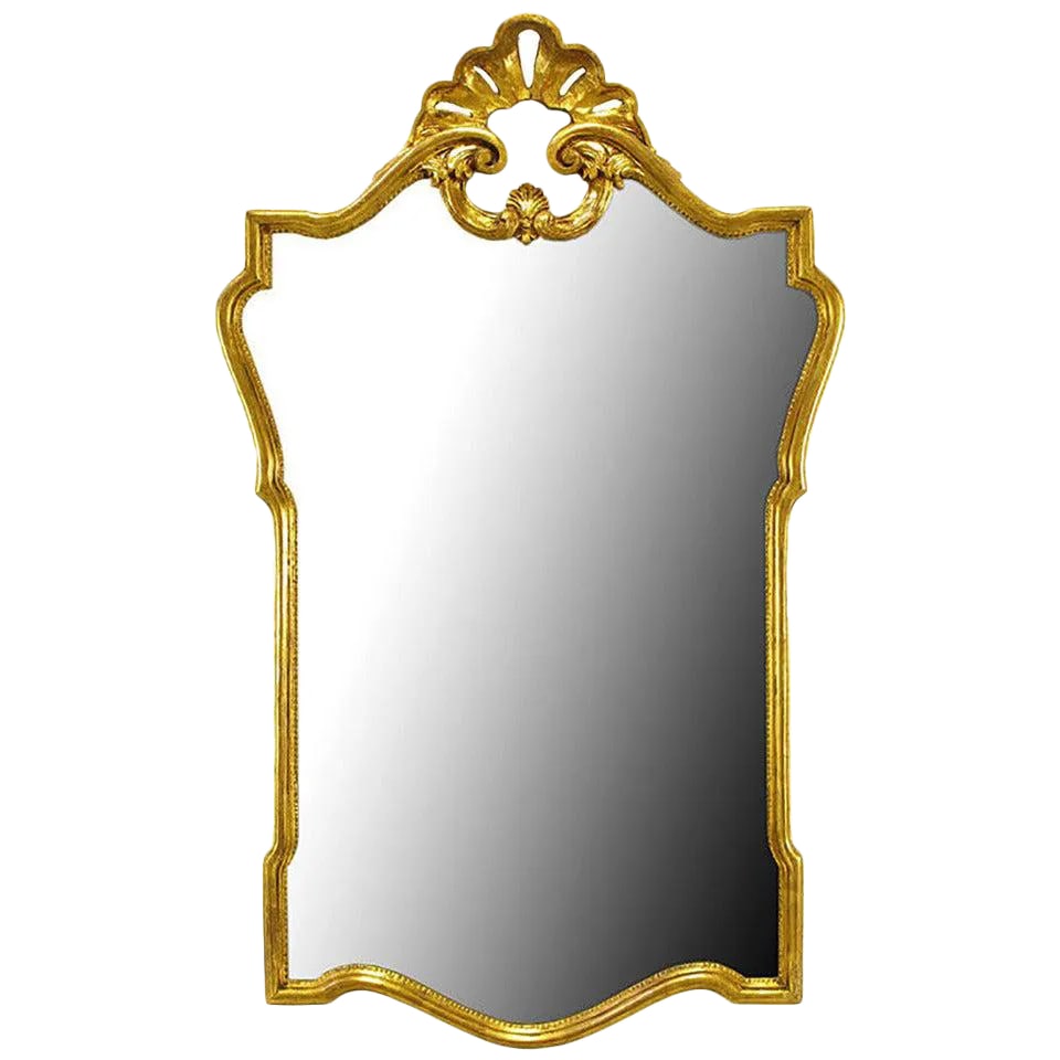 Gilt Carved Wood French Regency Style Mirror: Carved and giltwood French Regency style mirror with top filigree and shell motif. Well made and substantial in size. Most likely an Italian import. Condition: Alterations: Original Condition Unaltere