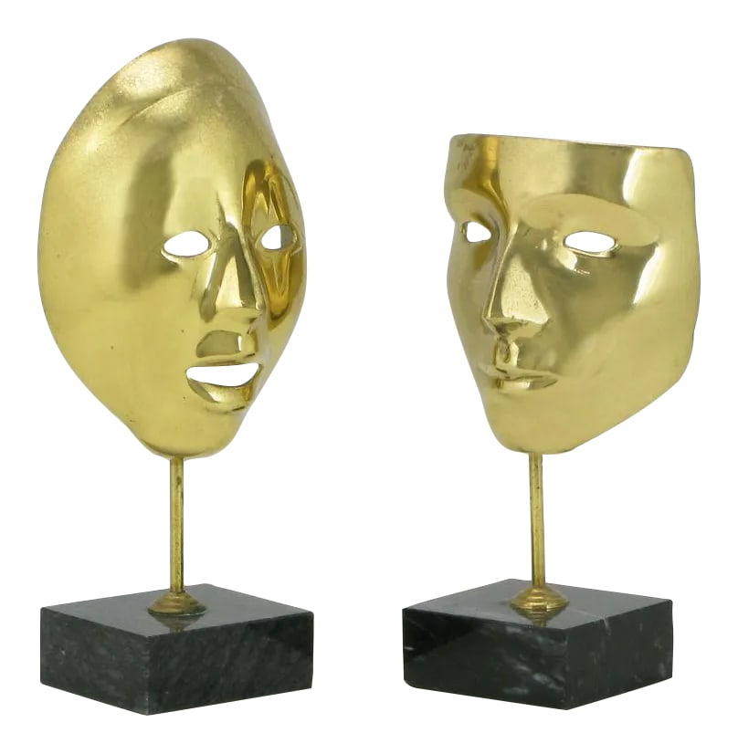 Brass Carnivale Masks Mounted on Black Marble - a Pair: Equisite pair of cast brass Carnivale masks mounted on black marble plinth bases. Very nicely patinated. Condition: Alterations: Original Condition Unaltered Imperfections: Some Imperfections Conditio