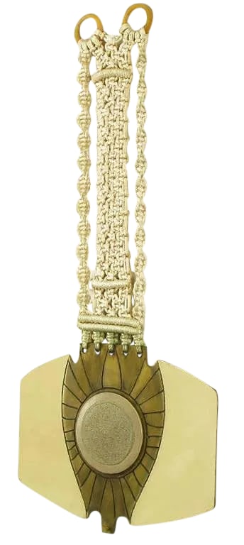Columbian-Inspired Brass and Terra Cotta Medallion Sculpture on Woven Mount: Columbian inspired mixed-media wall sculpture constructed of polished and fired brass with incised borders and loosely braided cord. Center terra cotta medallion. Lower knurled screw prevents the