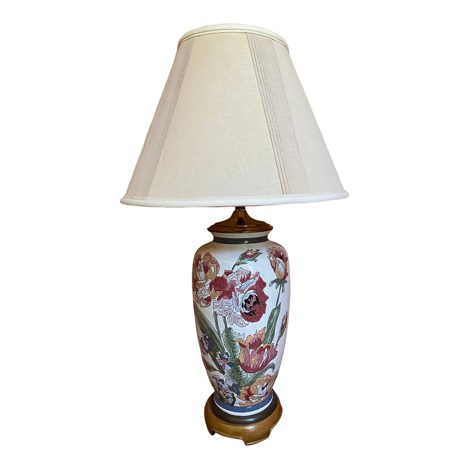 1990s Modern Flowered Porcelain Table Lamp With Wood Base: Beautiful 1990s table lamp with etched flowers in fall colors on white porcelain background. 360 degrees design. Wood pedestal base. Ecru shade. Condition: Alterations: Original Condition Unaltered