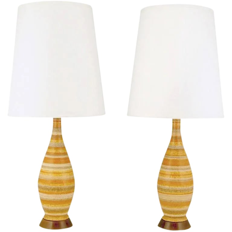 Striped Salt Glazed Pottery Table Lamps - a Pair: Hand thrown and glazed pottery bodies in organic earth tone stripping of red clay, browns and taupe. The bases are polished walnut. Sold sans shades. Condition: Alterations: Restored Imperfections: So