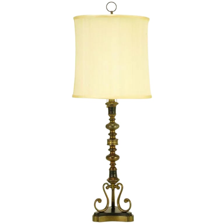 Brass & Black Leather Baluster Form Table Lamp: Segmented brass and black leather wrapped table lamp with three scrolled legs and reverse trefoil black lacquer and brass plinth base. Double socket illumination and pull chain switches. Sold sans