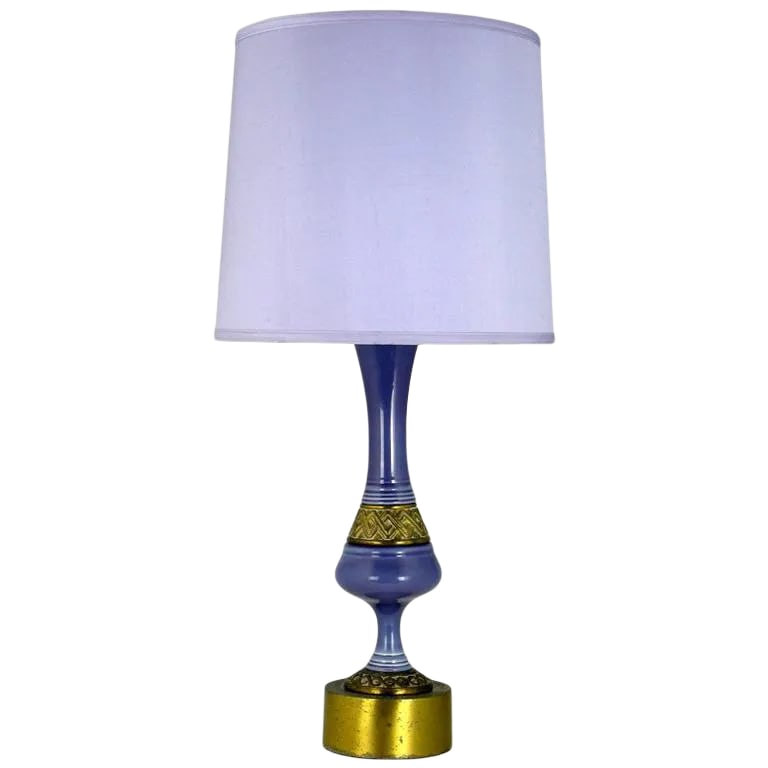 Single Ceramic Table Lamp in Amethyst and Brass: Statuesque table lamp,the body is a combination of brass and amethyst, leaning to periwinkle blue, glazed ceramic. The base has the original patina. Shade is for display only. Condition: Alterations: