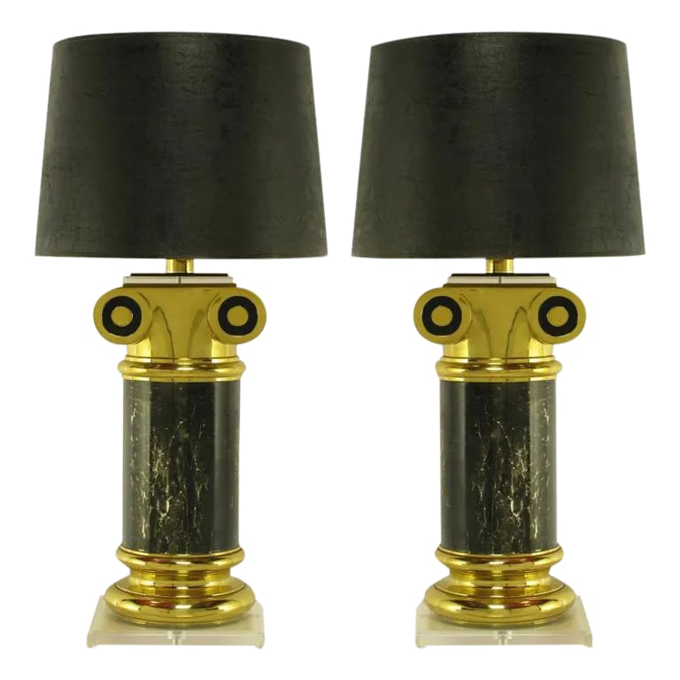Overscale Ionic Column Table Lamps in Brass & Lucite - a Pair: Pair of absurdly massive table lamps contain faux marble columns set into brass bases and surmounted by Ionic volutes. Clear Lucite plinths and clear and black Lucite capital tops add a modern feel to