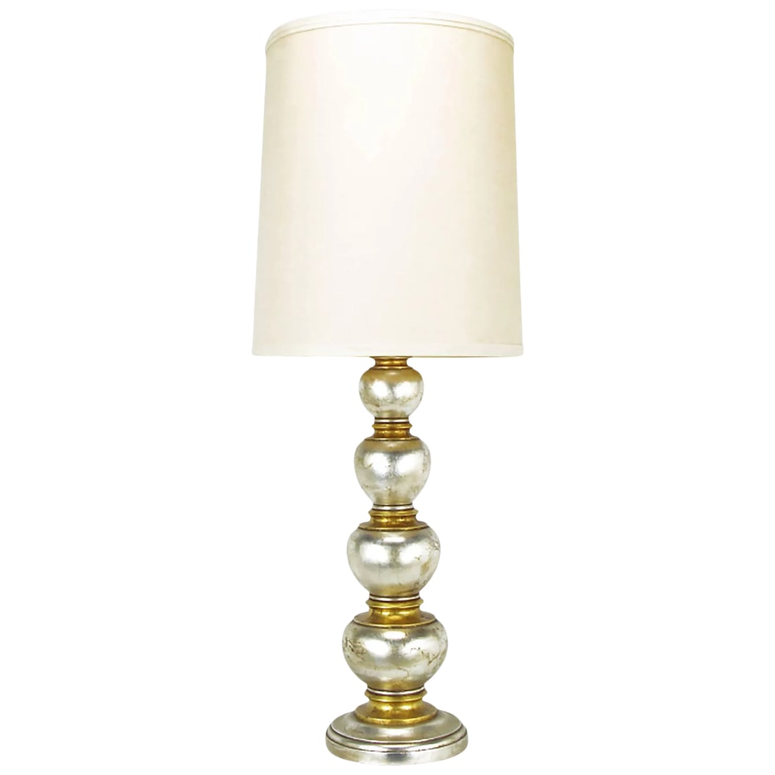 Frederick Cooper Silver and Gold Leaf Stacked Ball Table Lamp: Silver and gold leaf table lamp comprised of carved wood concentric ovals and flanged spacers by Frederick Cooper. In the manner of James Mont. Patinated brass socket cover with original milk glass di
