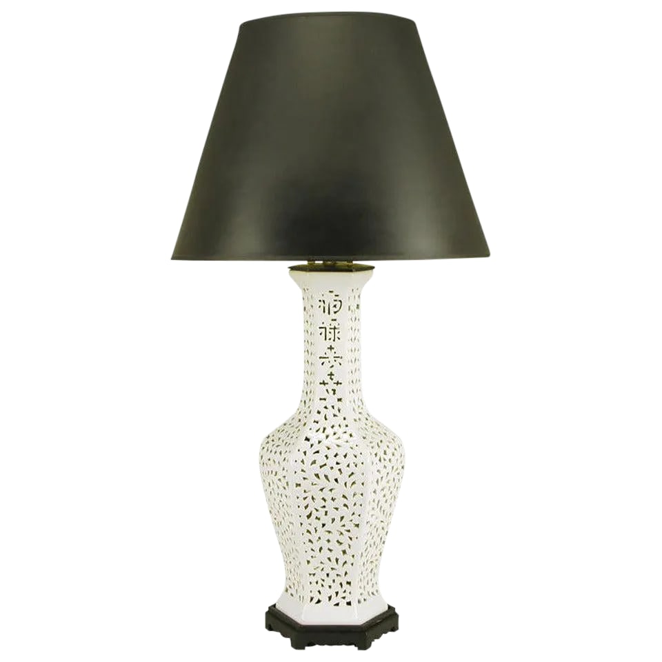 Large Reticulated Blanc De Chine Porcelain Table Lamp: Reticulated Blanc de Chine table lamp in hexagonal vase form, with Asian character design in the neck. Black lacquered wood base and metal cap with brass stem and dual socket illumination. Sold sans s