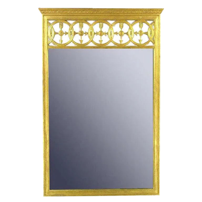 Large Italian Empire Gilt Mirror: A fine and well executed example of Italian Empire design. Open transom featuring interlocking circles and crossed arrows. The frame is carved wood and finished in patinated gilding. Possibly a Fratel