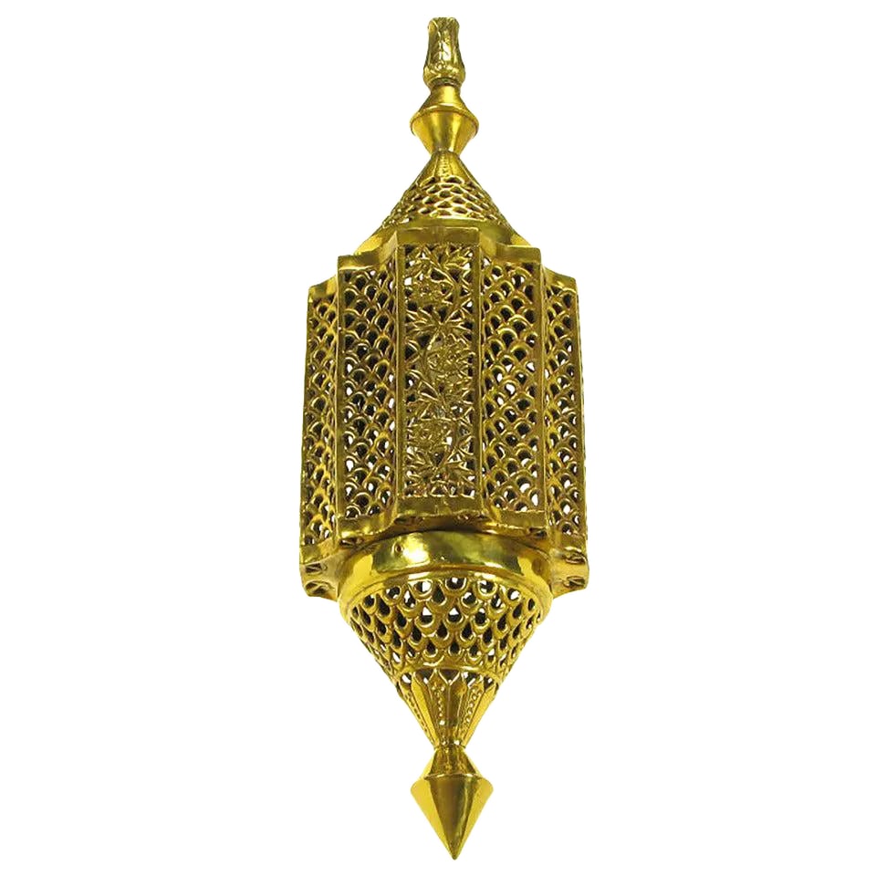Moroccan Style Reticulated Brass Pendant Light: Moroccan influenced pendulum shaped pendant light. Reticulated scalloped brass body with conical top and bottom casts a beautiful pattern of light when illuminated. Decorative cast brass segmented