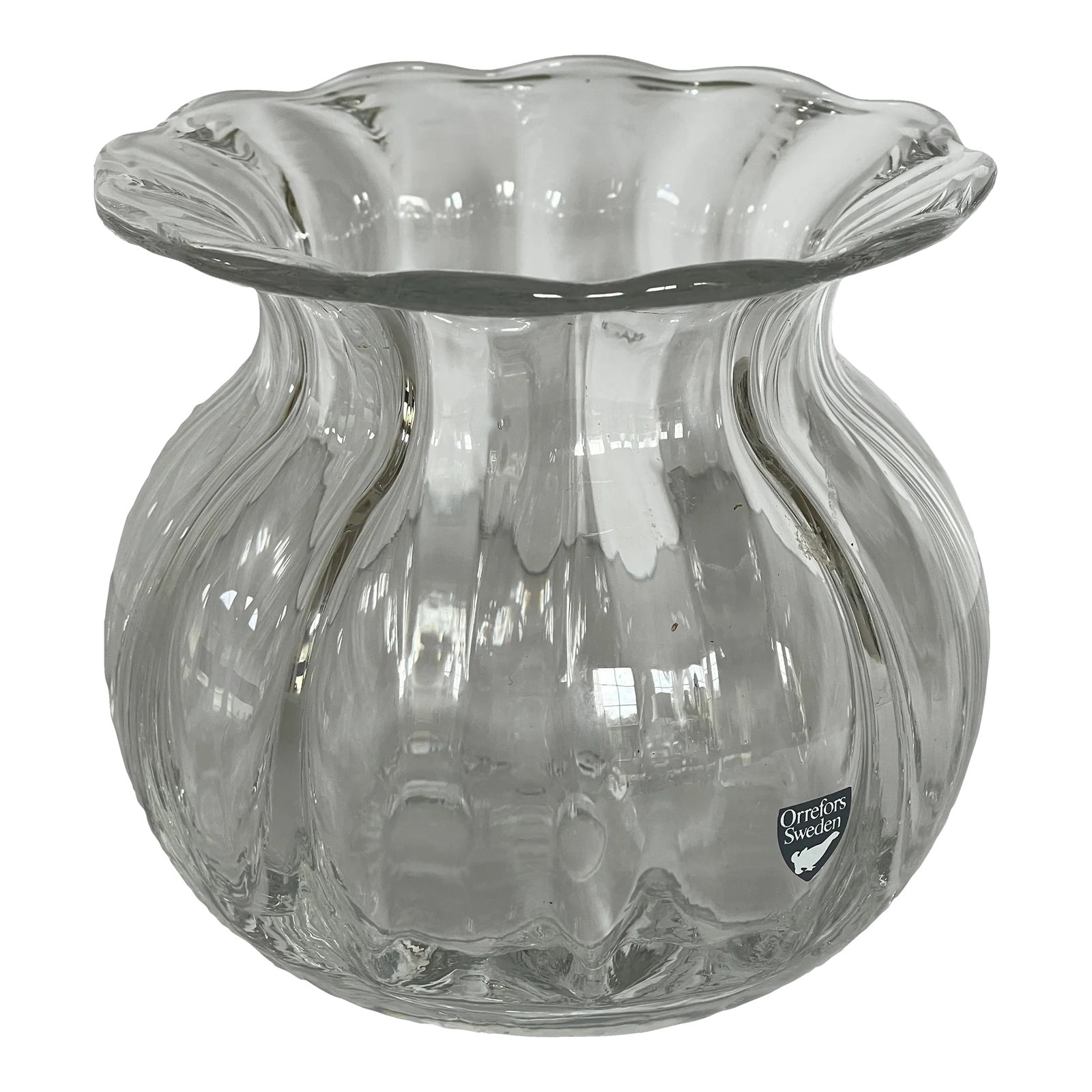 Late 20th Century Orrefors Swedish Ribbed Glass Anemone Vase: Orrefors curved ribbed crystal anemone vase with large open rim that opens out to highlight the flowers within. Original paper label, Orrefors Sweden. Condition: Alterations: Original Condition