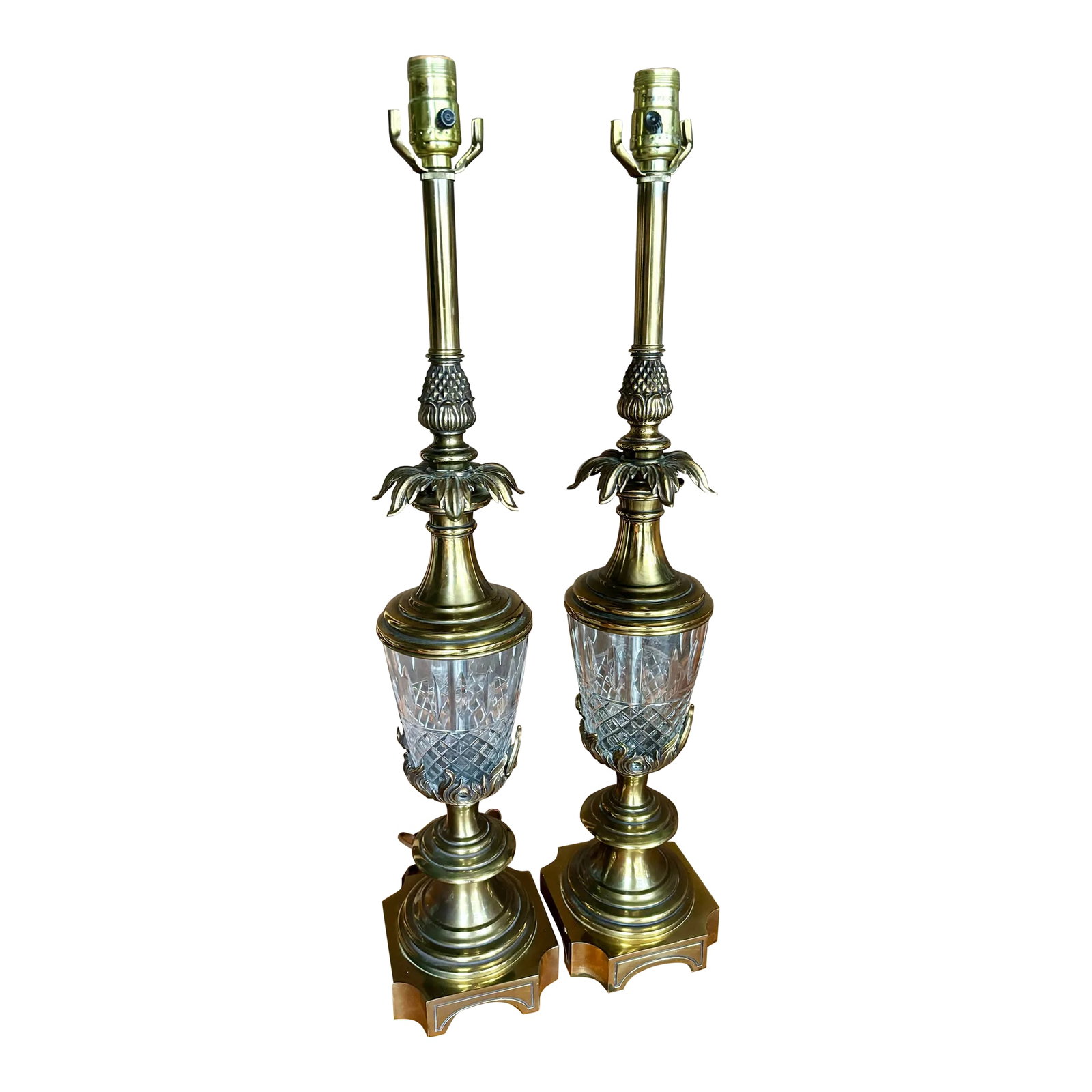 Pair of Vintage Stiffel Brass & Cut Crystal Pineapple Hollywood Regency Table Lamps: Striking pair of vintage Stiffel table lamps featuring substantial brass construction with beautifully cut crystal bodies and dramatic sculptural foliate details. The crystal is cut in a diamond