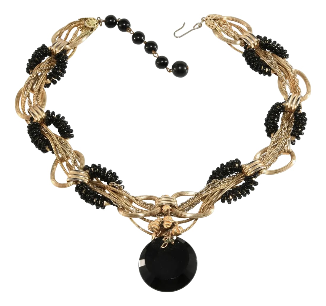 1960s Vintage Black Glass Necklace With Gold Plated Braided Chains: Vintage necklace featuring strands of gold plated chains braided together holding central black glass faceted disk. Other accents include black glass seed beads wrapped around several of the necklace