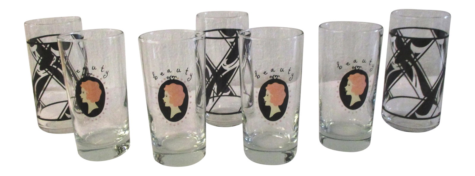 Classic Beauty Highball Glasses, Set of 7: Pretty nicely matched set of 1970s and 1980s highball glasses for the ladies bar. Set consists of four transparent glasses with a cameo women's design on face that says "beauty" matched with three