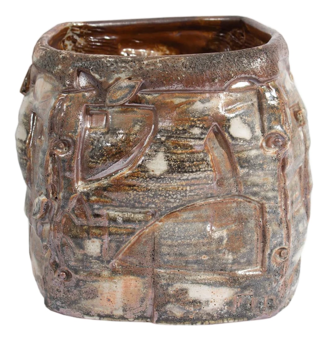 Barry Unitas Barnes Studio Pottery Planter: A studio pottery planter by the American artist Barry Unitas Barnes. This planter is wide-mouthed and stout with muted a brown, gray, and white glaze and a raised design. Barry Unitas Barnes received