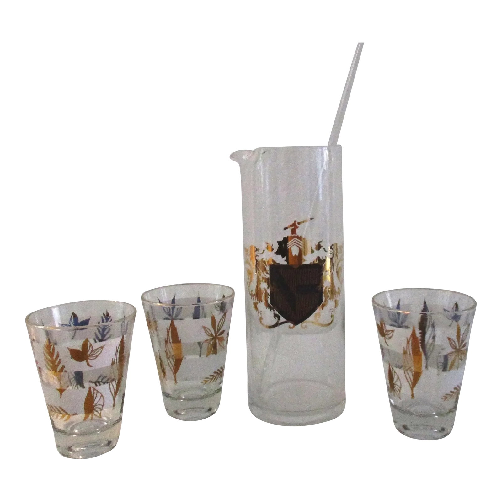 Mid-Century Knight Coat of Arms Cocktail Set, 5 Pcs: Stylish five piece cocktail set includes one clear glass pitcher featuring a knight coat of arms on front face of pitcher with generous gold accents, one glass stirrer, and three cocktail glasses feat